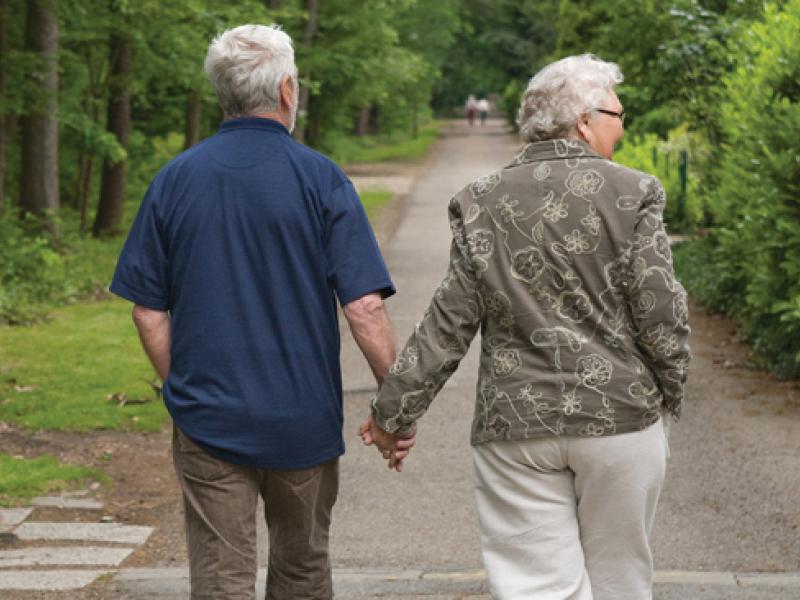 Older couple walking hand in hand